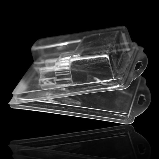 Two transparent closed blister packages stacked on top of each other against a black background.